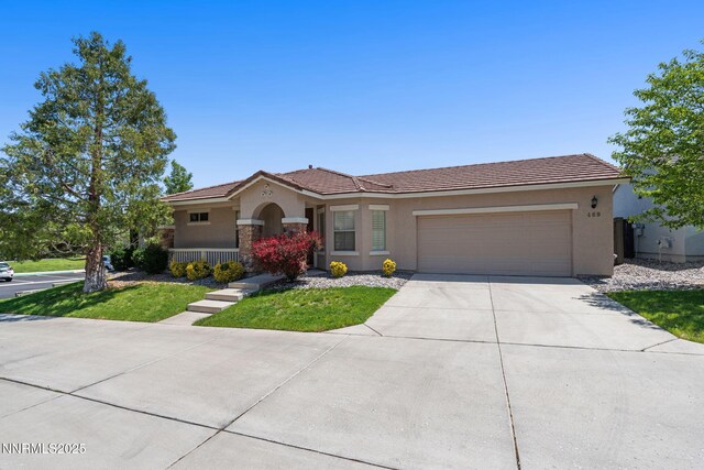 469 N Sand Crane Cir, Sparks, NV 89436 - mediterranean / spanish-style home featuring stucco siding, an attached garage, driveway, and a tiled roof