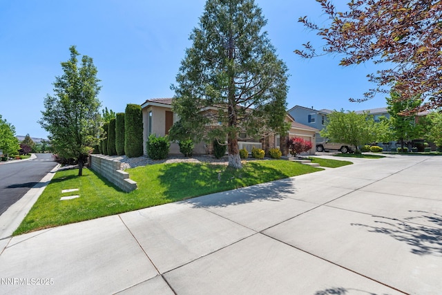 469 N Sand Crane Cir, Sparks, NV 89436 - obstructed view of property featuring a front lawn, concrete driveway, and a residential view