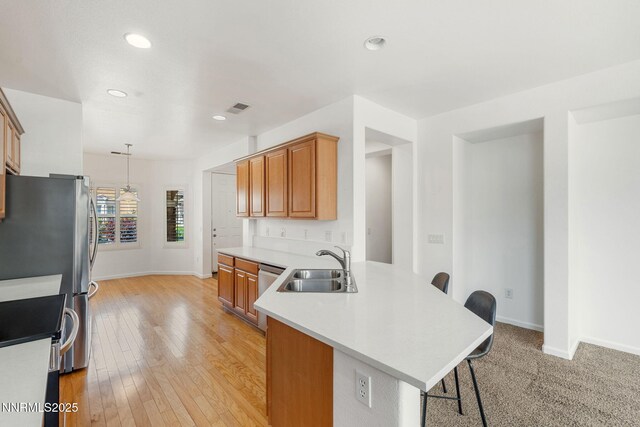 469 N Sand Crane Cir, Sparks, NV 89436 - kitchen with a kitchen bar, a sink, a peninsula, stainless steel range, and baseboards