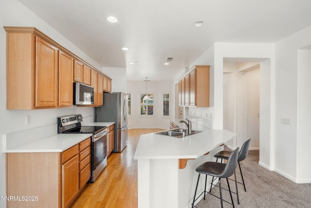 469 N Sand Crane Cir, Sparks, NV 89436 - kitchen featuring stainless steel appliances, a sink, a breakfast bar, a peninsula, and recessed lighting