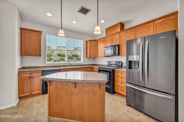 3074 Sterling Ridge Cir, Sparks, NV 89431 - kitchen with black appliances, a center island, pendant lighting, recessed lighting, and brown cabinetry