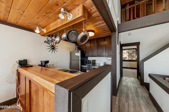 340 Quaking Aspen Ln # C, Stateline, NV 89449 - kitchen with appliances with stainless steel finishes, baseboards, wood finished floors, wooden ceiling, and dark brown cabinets