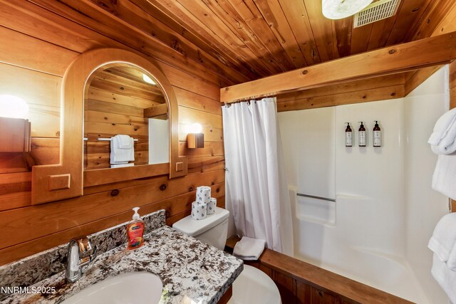 340 Quaking Aspen Ln # C, Stateline, NV 89449 - bathroom with toilet, vanity, wooden ceiling, and wood walls