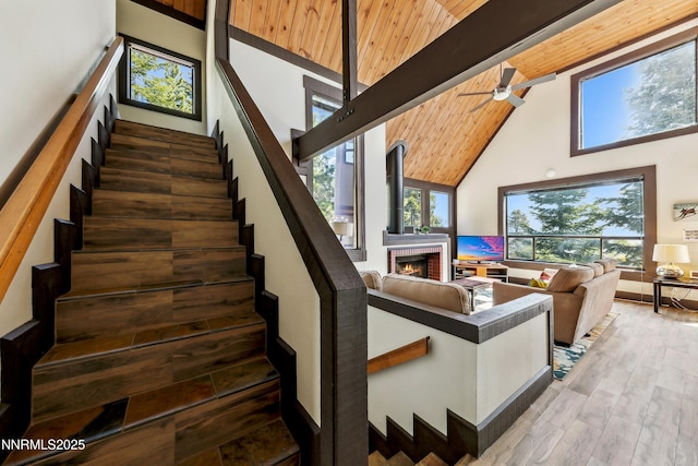 340 Quaking Aspen Ln # C, Stateline, NV 89449 - stairs featuring high vaulted ceiling, a fireplace, ceiling fan, wood finished floors, and wood ceiling with exposed beams