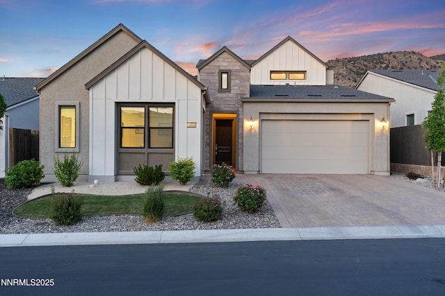 15058 Iron River Dr, Reno, NV 89521 - view of front of property featuring board and batten siding, an attached garage, and driveway