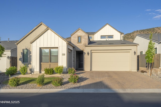 15058 Iron River Dr, Reno, NV 89521 - modern inspired farmhouse featuring board and batten siding, decorative driveway, and an attached garage