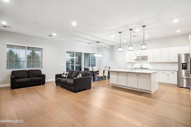 15058 Iron River Dr, Reno, NV 89521 - living area featuring recessed lighting, light wood-style floors, plenty of natural light, and baseboards