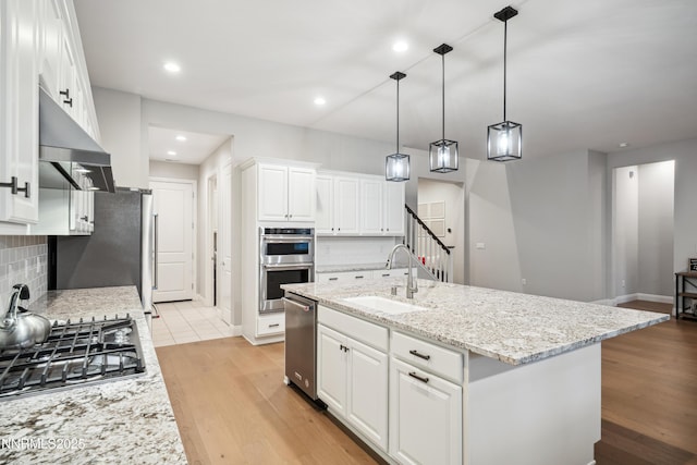 15058 Iron River Dr, Reno, NV 89521 - kitchen with a sink, appliances with stainless steel finishes, backsplash, white cabinetry, and recessed lighting