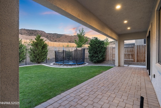 15058 Iron River Dr, Reno, NV 89521 - view of yard with a patio area, a trampoline, and a mountain view