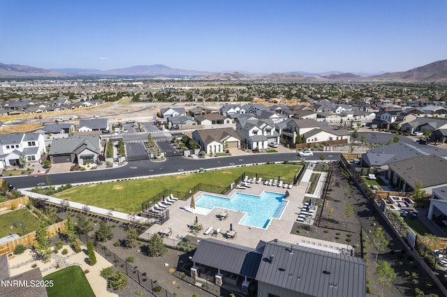 15058 Iron River Dr, Reno, NV 89521 - aerial perspective of suburban area with a pool area and a mountain backdrop