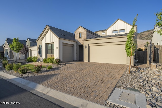 15058 Iron River Dr, Reno, NV 89521 - modern farmhouse featuring board and batten siding, an attached garage, and driveway