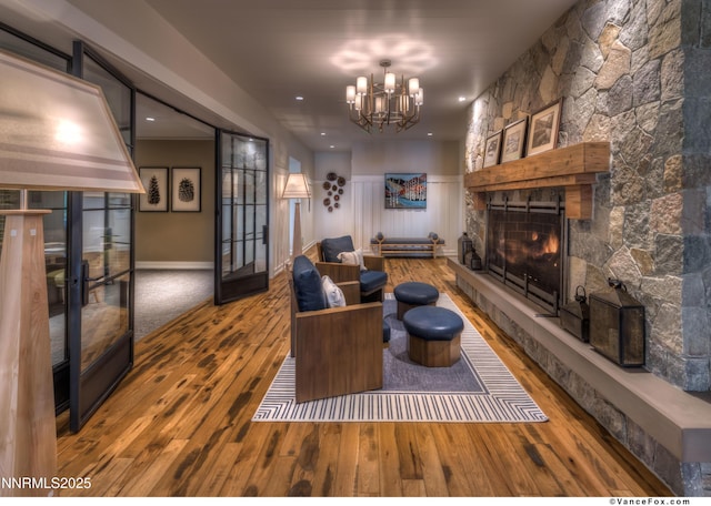 33 Beach Club Dr Unit 506, Stateline, NV 89449 - living room with hardwood / wood-style floors, a fireplace, a chandelier, french doors, and wainscoting
