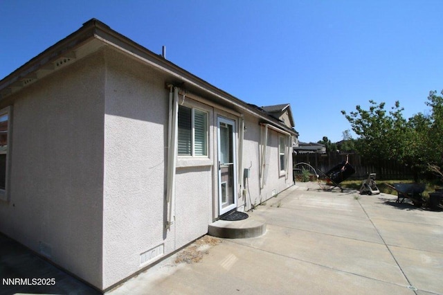 7378 Silver Dawn Dr, Reno, NV 89506 - view of side of home with a patio area and stucco siding