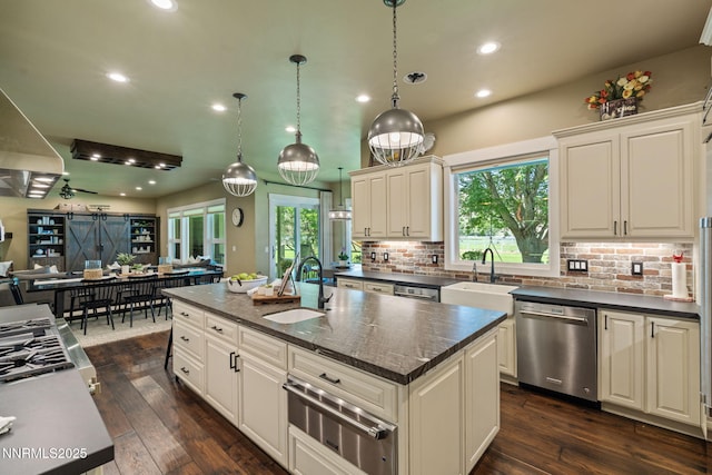 1020 N Cantlon Ln, Reno, NV 89521 - kitchen with stainless steel dishwasher, a warming drawer, a sink, open floor plan, and recessed lighting