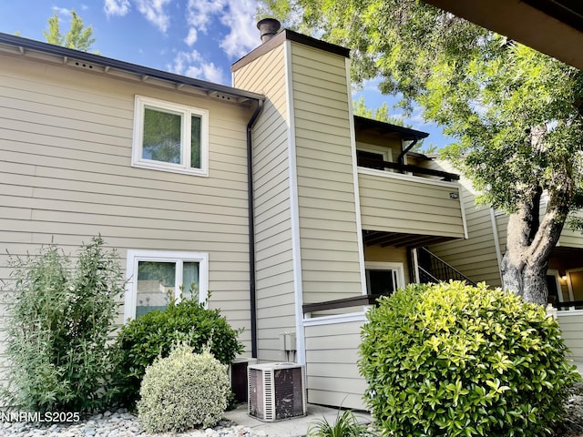 555 E Patriot Blvd, Reno, NV 89511 - back of house featuring a chimney, a balcony, and cooling unit
