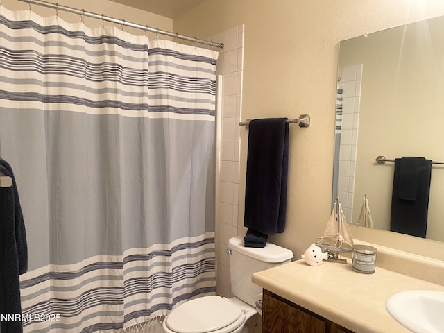 555 E Patriot Blvd, Reno, NV 89511 - full bath featuring toilet, vanity, a textured wall, and a shower with curtain