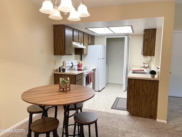 555 E Patriot Blvd, Reno, NV 89511 - kitchen featuring white appliances, under cabinet range hood, a sink, a chandelier, and light countertops