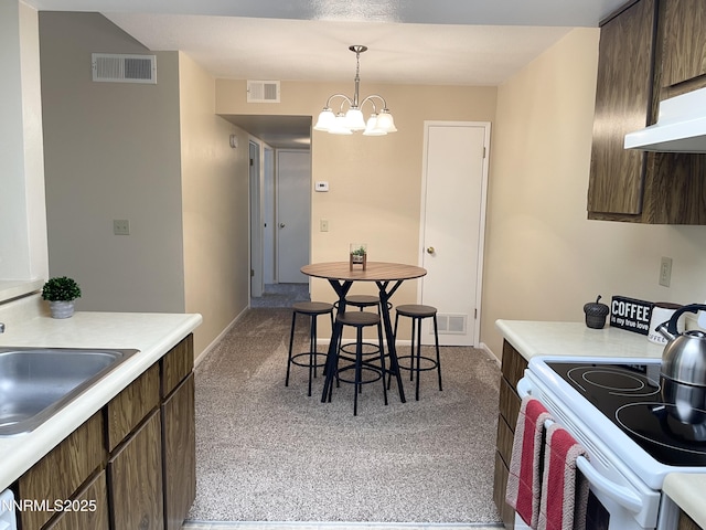 555 E Patriot Blvd, Reno, NV 89511 - kitchen featuring white range with electric cooktop, light carpet, and light countertops