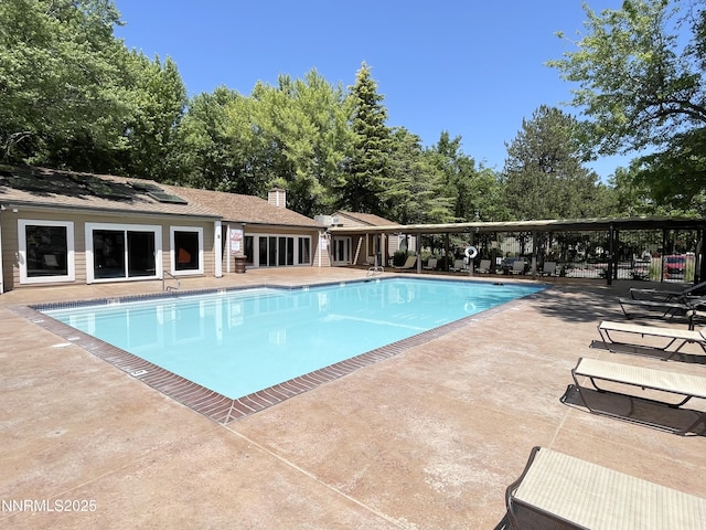 555 E Patriot Blvd, Reno, NV 89511 - community pool with a patio and view of wooded area