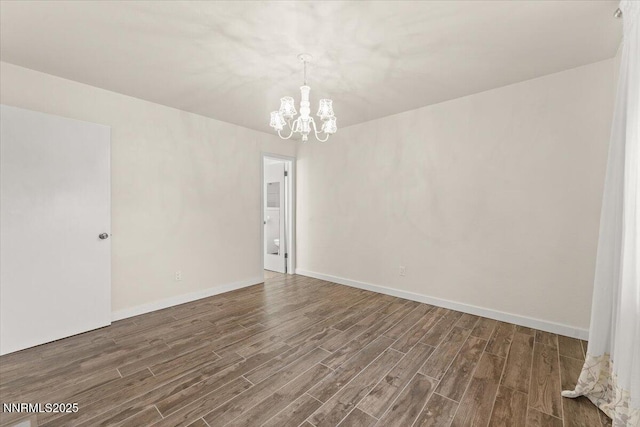 7620 Essex Way, Reno, NV 89506 - unfurnished room featuring a chandelier, wood finished floors, and baseboards