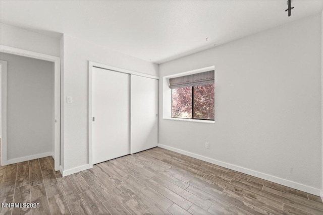 7620 Essex Way, Reno, NV 89506 - unfurnished bedroom featuring a closet, wood finished floors, and baseboards