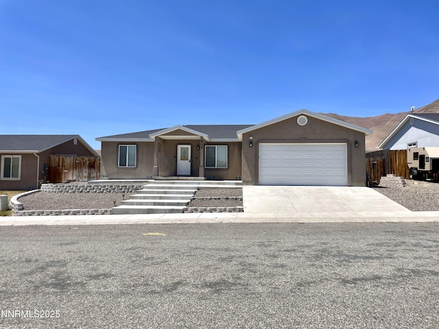 935 Lonnie Ln, Winnemucca, NV 89445 - ranch-style home featuring an attached garage, concrete driveway, and stucco siding