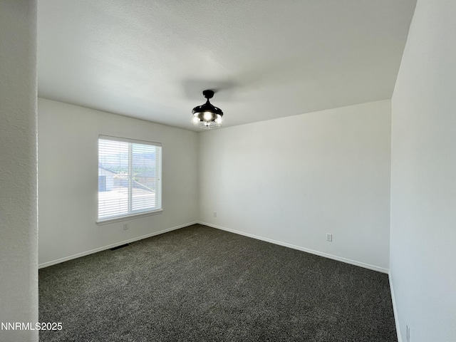935 Lonnie Ln, Winnemucca, NV 89445 - empty room featuring dark carpet and baseboards