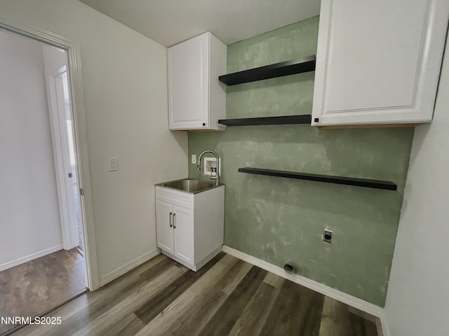 935 Lonnie Ln, Winnemucca, NV 89445 - laundry area featuring hookup for an electric dryer, dark wood-style floors, washer hookup, cabinet space, and baseboards