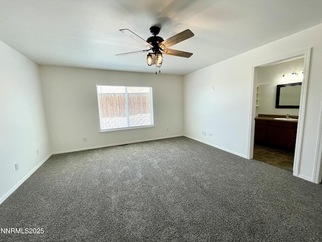 935 Lonnie Ln, Winnemucca, NV 89445 - unfurnished bedroom featuring a sink, carpet flooring, baseboards, and connected bathroom