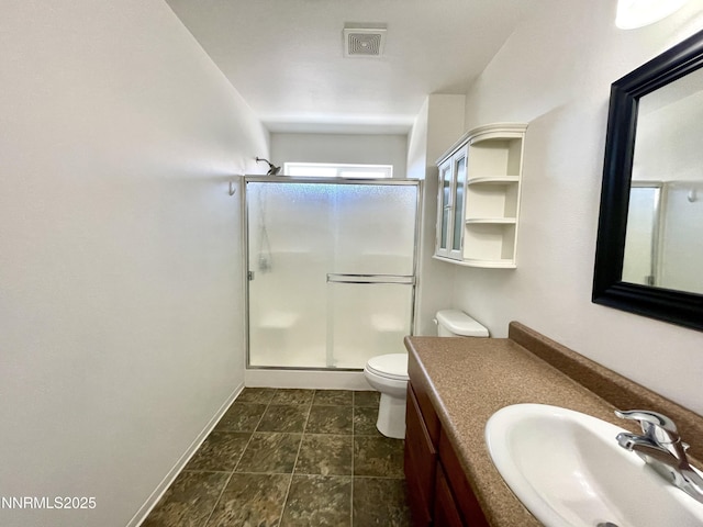 935 Lonnie Ln, Winnemucca, NV 89445 - bathroom featuring vanity, a stall shower, toilet, and baseboards