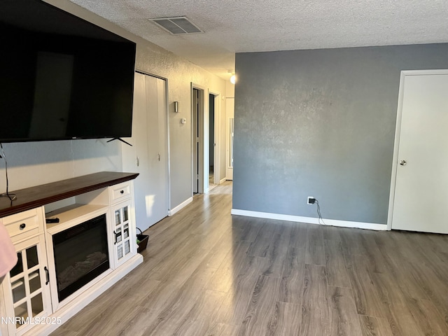 540 Anthony Ln, Fallon, NV 89406 - unfurnished living room with wood finished floors and a textured ceiling