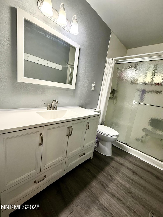 540 Anthony Ln, Fallon, NV 89406 - full bath featuring a textured wall, a shower stall, wood finished floors, and vanity