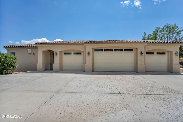 14210 Wild Quail Ct, Reno, NV 89511 - view of front facade featuring driveway, stucco siding, a tile roof, and an attached garage