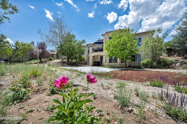 14210 Wild Quail Ct, Reno, NV 89511 - view of front of property featuring a balcony, stucco siding, and a tiled roof