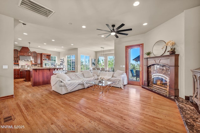 14210 Wild Quail Ct, Reno, NV 89511 - living area featuring light wood-style flooring, recessed lighting, a premium fireplace, and ceiling fan