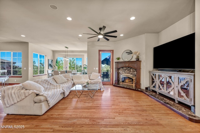 14210 Wild Quail Ct, Reno, NV 89511 - living area featuring wood finished floors, a fireplace, recessed lighting, and ceiling fan