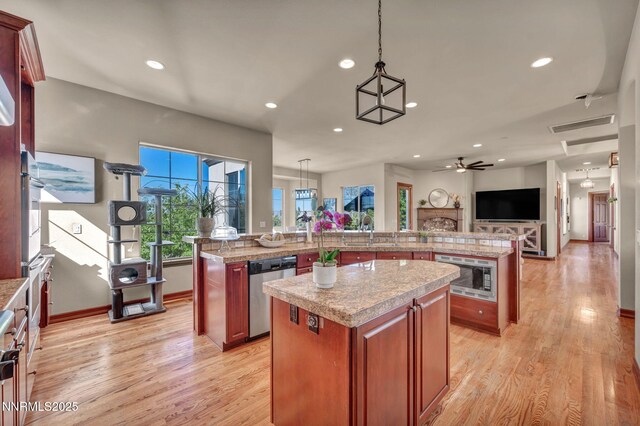 14210 Wild Quail Ct, Reno, NV 89511 - kitchen featuring stainless steel appliances, a large island, light countertops, light wood-style floors, and recessed lighting