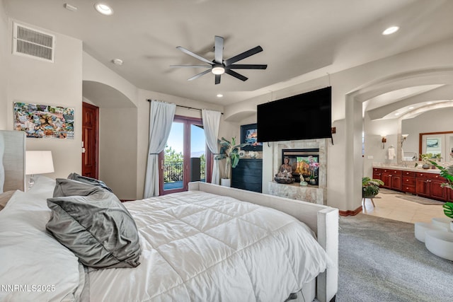 14210 Wild Quail Ct, Reno, NV 89511 - bedroom featuring arched walkways, a multi sided fireplace, recessed lighting, a ceiling fan, and ensuite bathroom