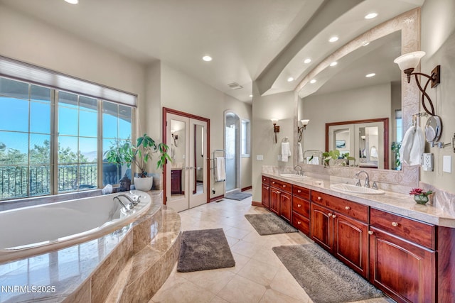 14210 Wild Quail Ct, Reno, NV 89511 - bathroom with double vanity, recessed lighting, a garden tub, tile patterned flooring, and french doors