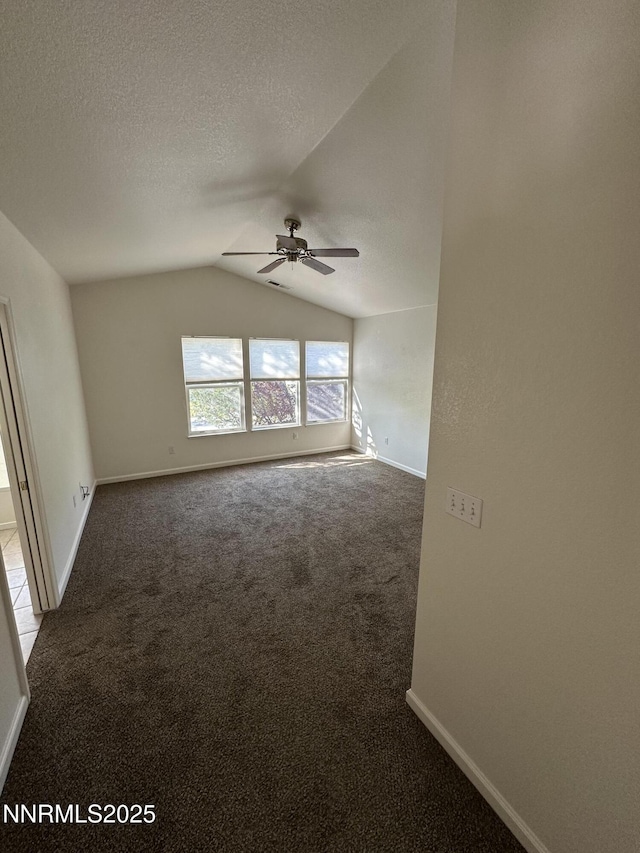 4748 Cedarhill Ln, Reno, NV 89519 - carpeted empty room featuring ceiling fan, vaulted ceiling, a textured ceiling, and baseboards