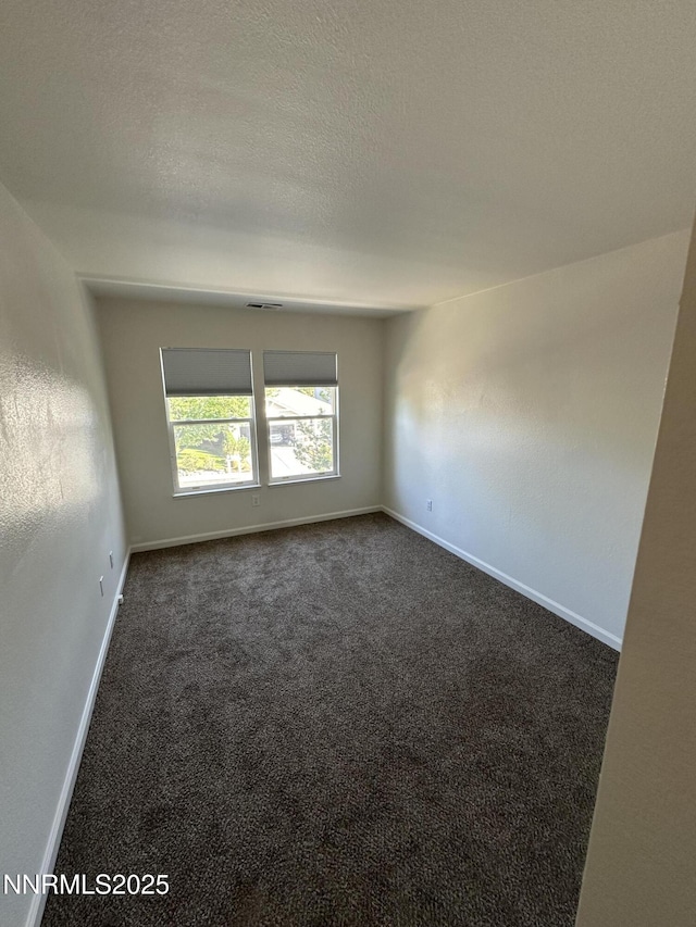 4748 Cedarhill Ln, Reno, NV 89519 - spare room with dark colored carpet and baseboards