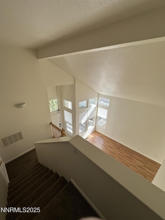 4748 Cedarhill Ln, Reno, NV 89519 - stairs with wood finished floors, a textured ceiling, and baseboards