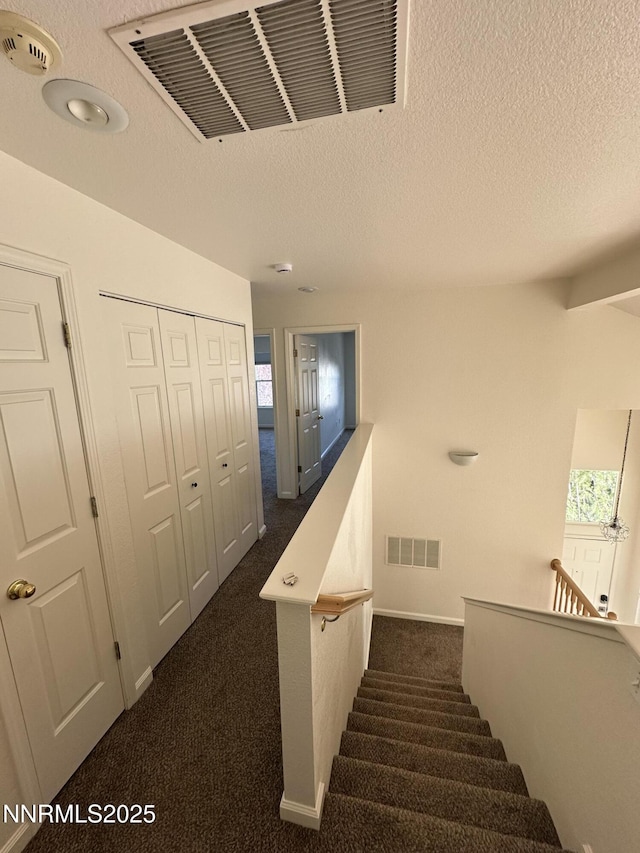 4748 Cedarhill Ln, Reno, NV 89519 - staircase featuring carpet floors, baseboards, and a textured ceiling