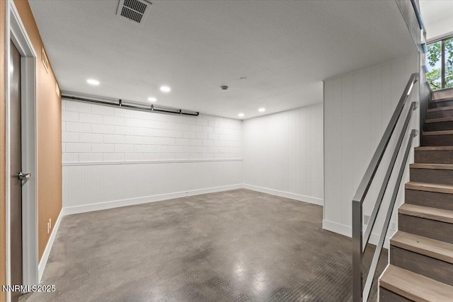 1308 Jones St, Reno, NV 89503 - basement with stairway, baseboards, recessed lighting, and a textured ceiling