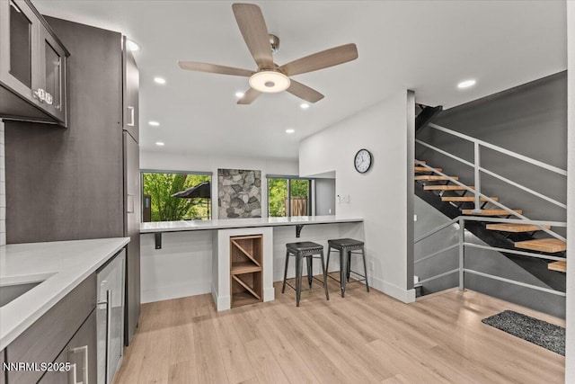 1308 Jones St, Reno, NV 89503 - kitchen with light wood-type flooring, a ceiling fan, baseboards, light countertops, and recessed lighting