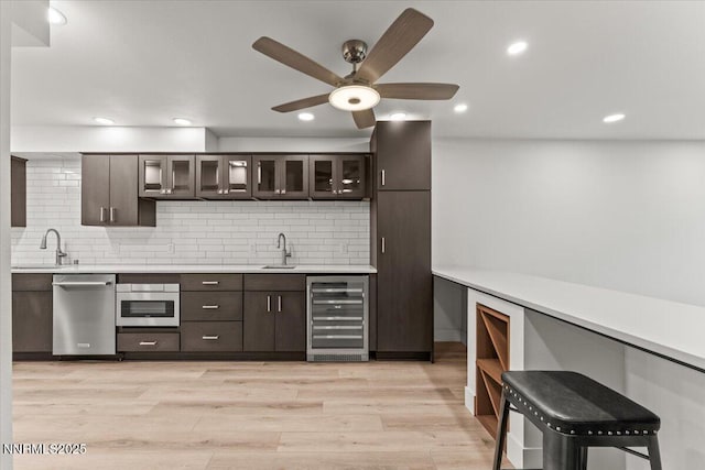1308 Jones St, Reno, NV 89503 - indoor wet bar with wine cooler, appliances with stainless steel finishes, ceiling fan, tasteful backsplash, and recessed lighting