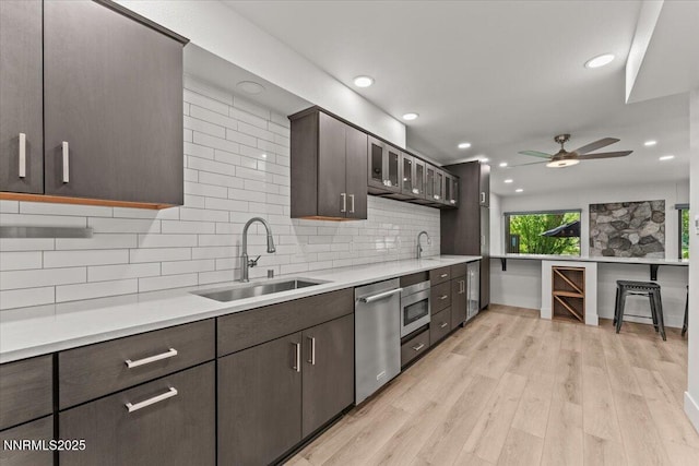 1308 Jones St, Reno, NV 89503 - kitchen with a sink, stainless steel dishwasher, dark brown cabinetry, decorative backsplash, and recessed lighting