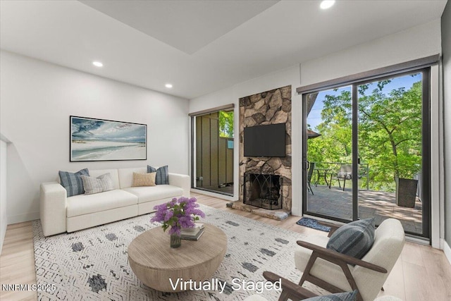 1308 Jones St, Reno, NV 89503 - living area with recessed lighting, a fireplace, light wood-style floors, and baseboards