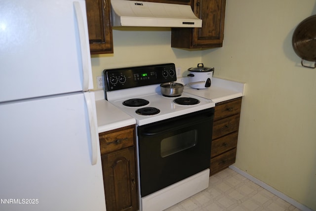 461 Debbie Dr, Walker Lake, NV 89415 - kitchen featuring freestanding refrigerator, range with electric cooktop, premium range hood, light floors, and dark brown cabinetry