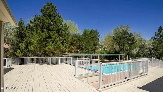 1169 Wagon Wheel Cir, Reno, NV 89503 - community pool featuring view of wooded area and a wooden deck